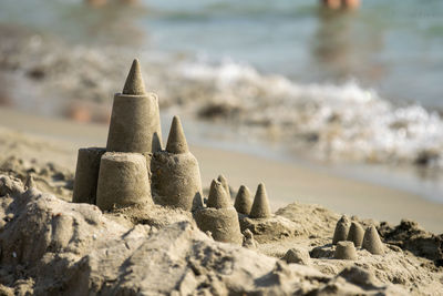 Close-up of stones, sand castel on beach