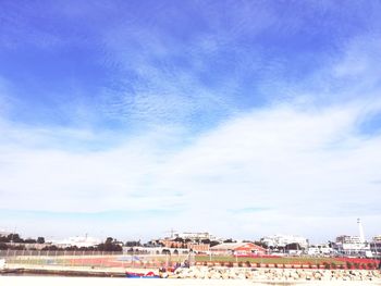 Scenic view of beach against sky in city