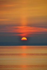 Scenic view of sea against romantic sky at sunset