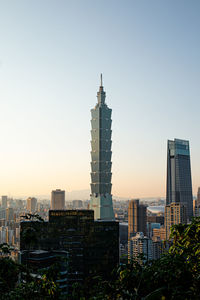 Buildings in city against clear sky