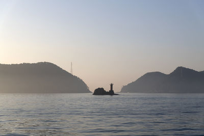 Boat sailing on sea against sky during sunset