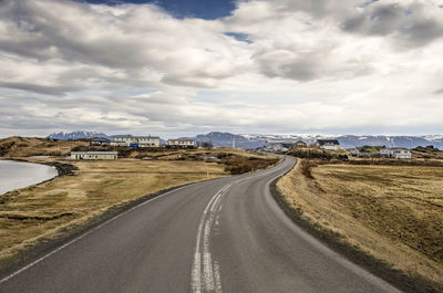 Curving asphalt road to the village on the edge of the pseudocrater area on the shore of lake myvatn