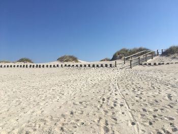 Panoramic view of beach against clear blue sky