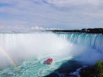 Scenic view of waterfall against sky