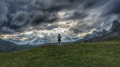 Man standing on field against sky