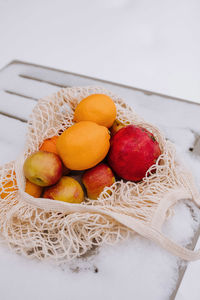 High angle view of fresh fruits in basket on table