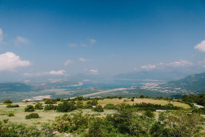 Scenic view of landscape and sea against sky