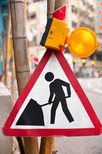 Close-up of arrow sign on road