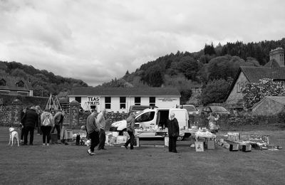 Group of people by buildings against sky