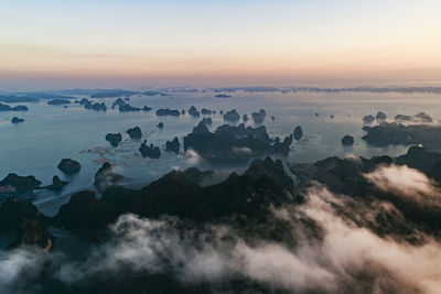 Aerial view of sea against sky during sunset