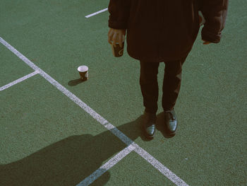 Low section of man standing on ball