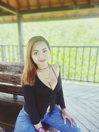 Portrait of young woman sitting outdoors