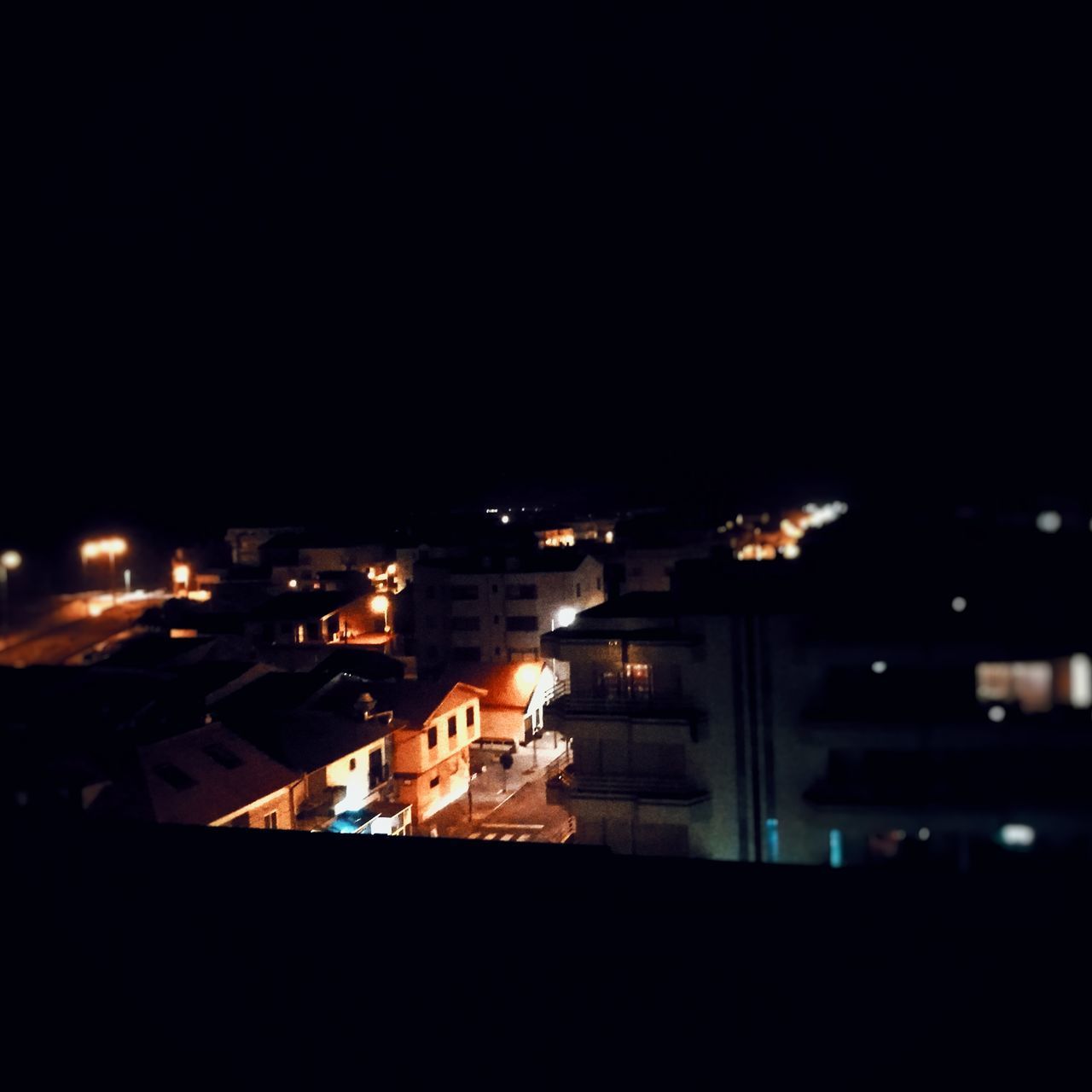 ILLUMINATED CITYSCAPE AGAINST SKY AT NIGHT