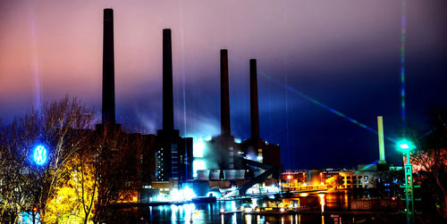 Panoramic view of illuminated buildings against sky at night