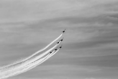 Low angle view of airplane flying against sky airshow