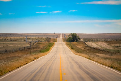 Highway amidst landscape against sky