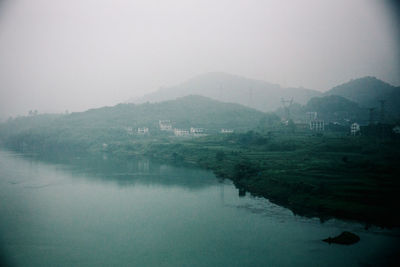 Scenic view of lake in foggy weather