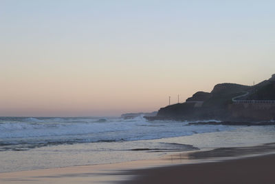 Scenic view of sea against clear sky during sunset