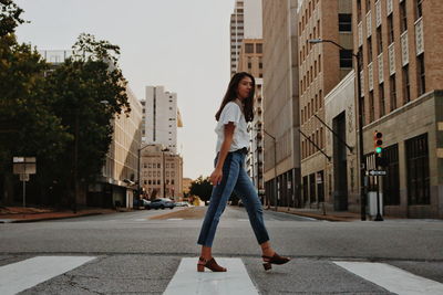 Woman crossing street in city