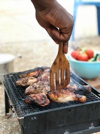 Man preparing food on barbecue grill