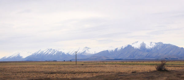 Scenic view of landscape and mountains against sky