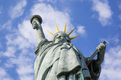 Low angle view of statue of liberty against sky