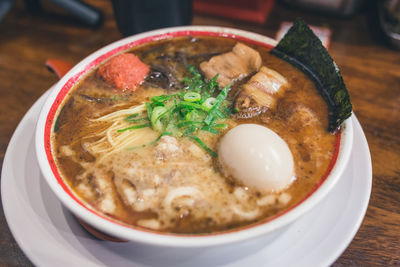 Close-up of soup served on wooden table