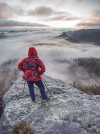 Woman hiker stop at the end of path on edge. mystery misty landscape. woman enjoy the deep silence.