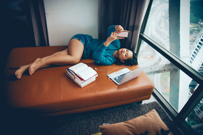 Full length of man lying down on table