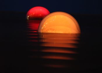 Close-up of light bulb over black background