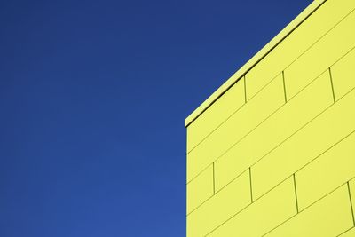 Low angle view of building against clear blue sky