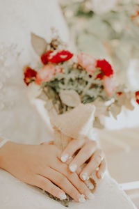 Midsection of woman holding flower bouquet