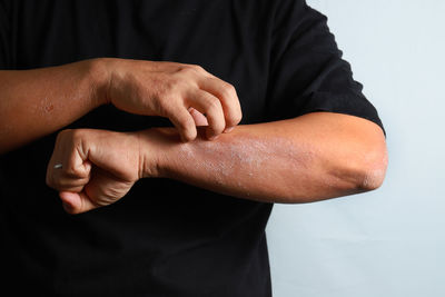 Close-up of man hand over black background