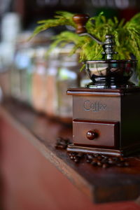 Close-up of coffee beans and grinder on table