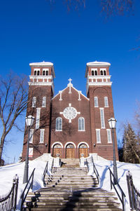 Double tower, brick church against a blue sky