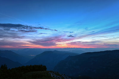 Scenic view of silhouette mountains against sky during sunset