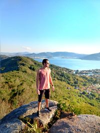 Full length of man standing on mountain against sky