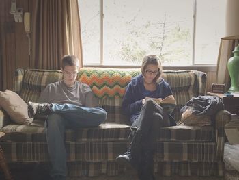 Men sitting on sofa at home