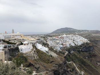 High angle view of townscape by sea against sky