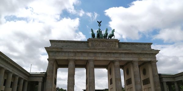 Low angle view of statue against cloudy sky