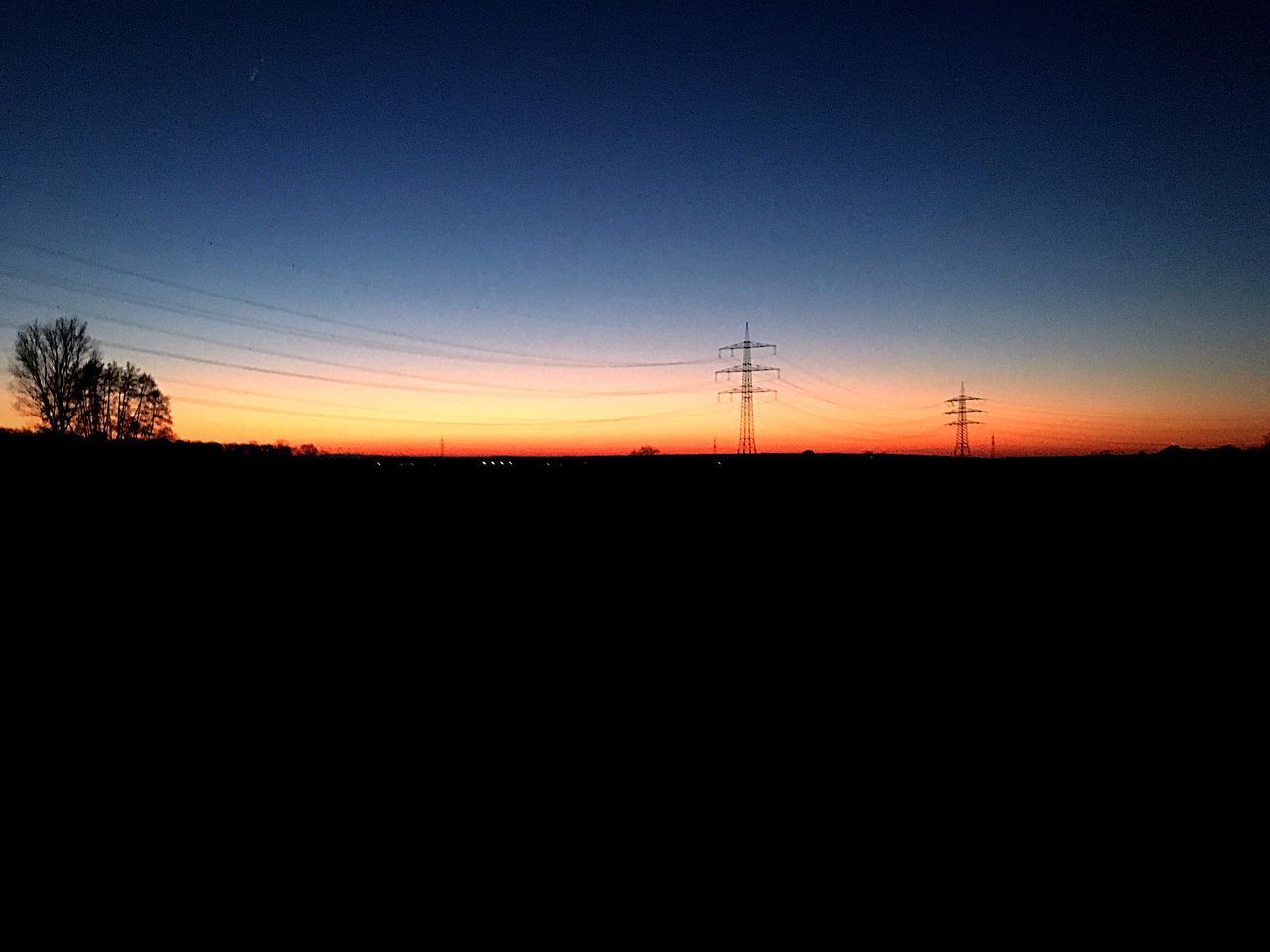 SILHOUETTE LANDSCAPE AGAINST CLEAR SKY DURING SUNSET