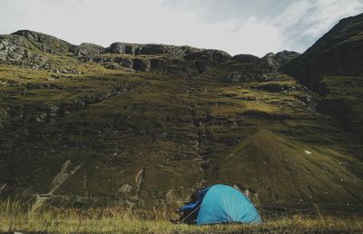 View of tent on mountain against sky
