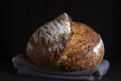 Close-up of bread against black background