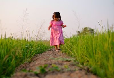 Full length of woman standing on field
