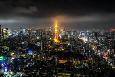 High angle view of illuminated buildings against sky at night