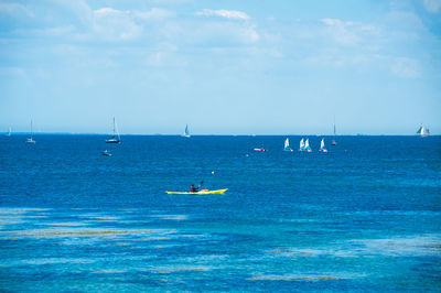 Sailboat in sea against sky