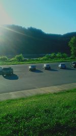 Cars on road against clear sky