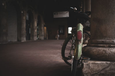 Bicycle parked on street against building