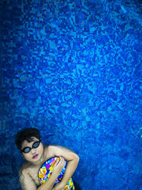 High angle view of boy swimming in pool