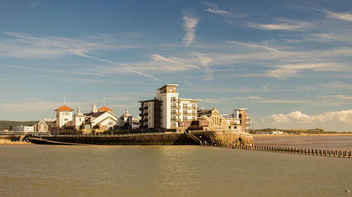 City by river against sky